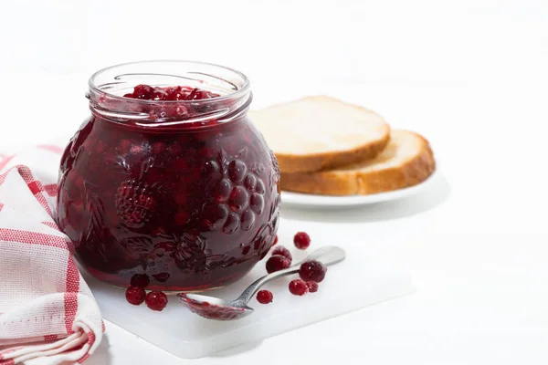 Jar of cranberry jam on a white table — Stock Photo, Image