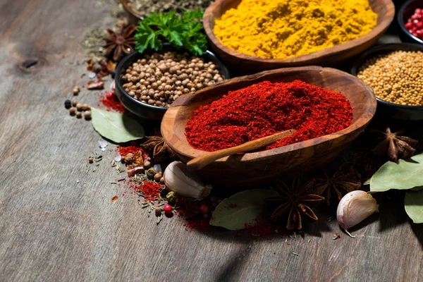 Assortment of spices and herbs on a wooden table — Stock Photo, Image
