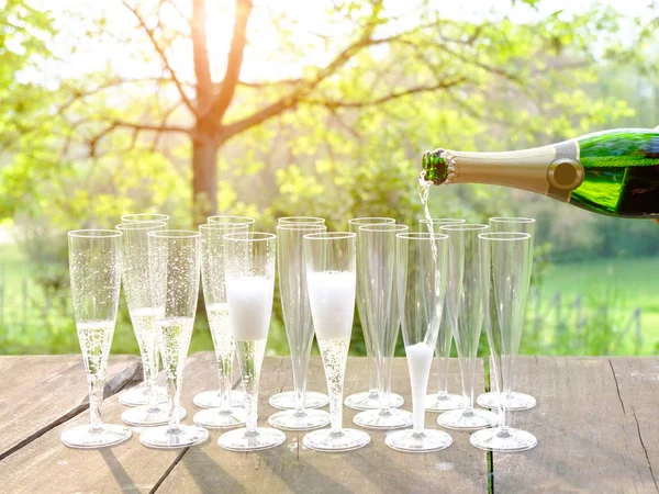 Hand gießt Wein in Sektgläser — Stockfoto