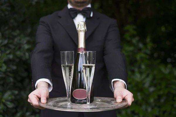 Professional waiter in uniform is serving champagne — Stock Photo, Image