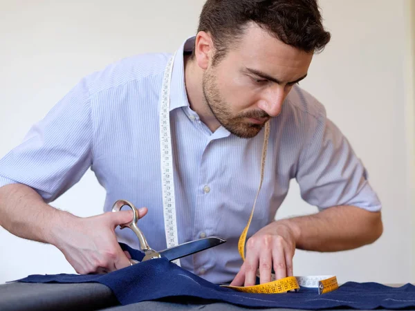 Tailor man working in his tailor shop — Stock Photo, Image