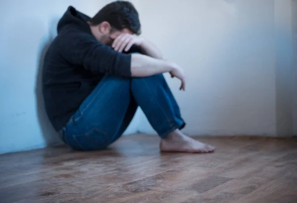 Desperate young man in an empty room