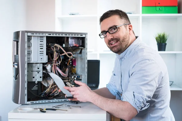 Professional man repairing and assembling a computer desktop