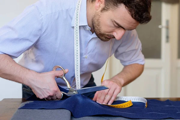 Tailor man working in his tailor shop — Stock Photo, Image