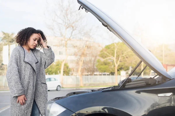 Wanhopige vrouw na het controleren van gebroken motor van de auto — Stockfoto