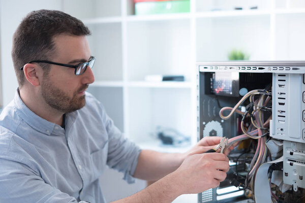 Professional man repairing and assembling a computer
