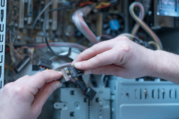 Professional man repairing and assembling a computer