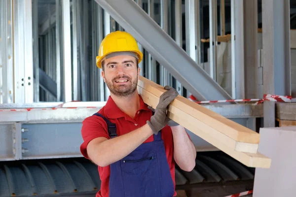 Carpenter worker holding wooden boards Royalty Free Stock Images