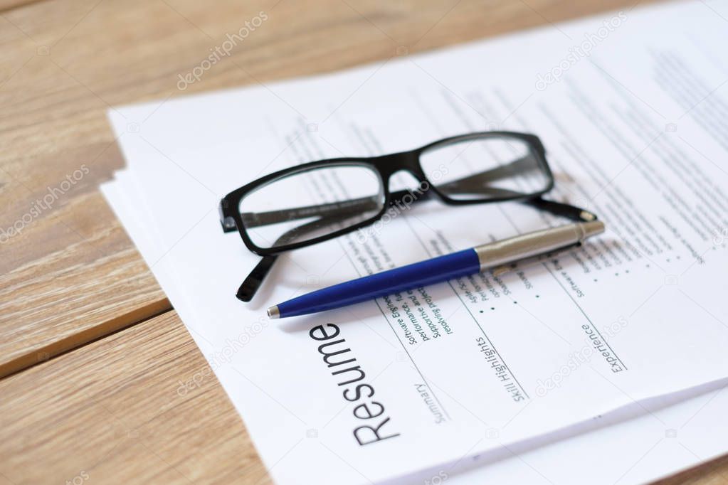 Resume application on wooden desk ready to be reviewed