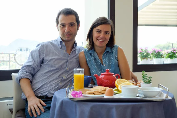 Couple having breakfast in hotel during vacations