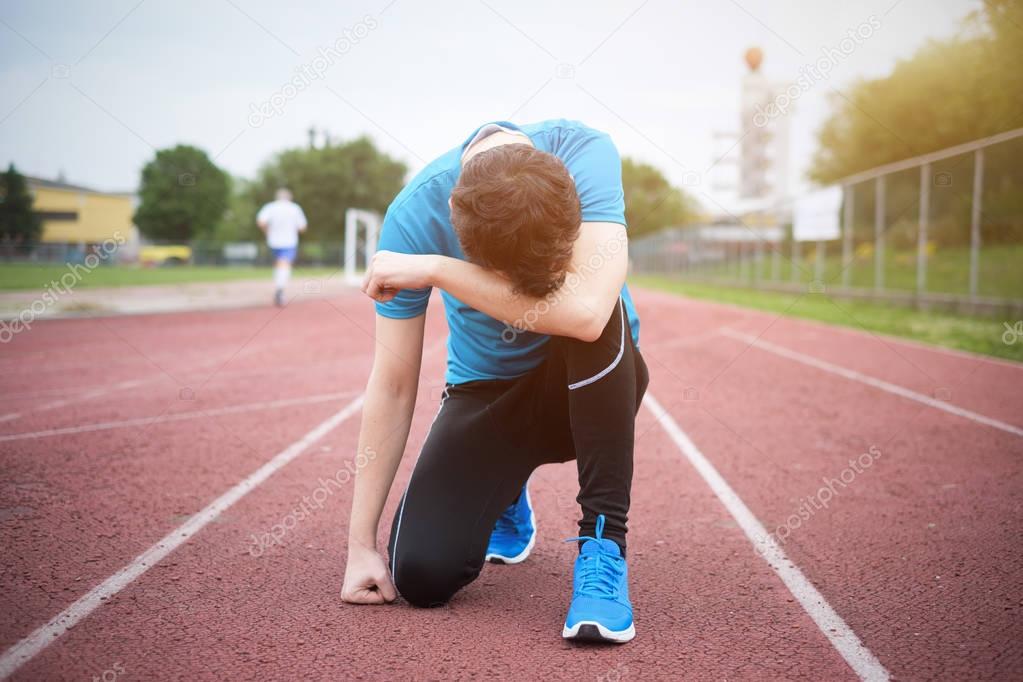 Tired sportsman feeling exhausted and defeated