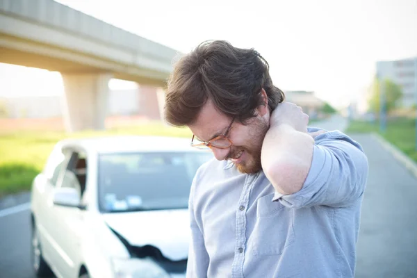 男の車がクラッシュした後の首に痛みを感じて — ストック写真