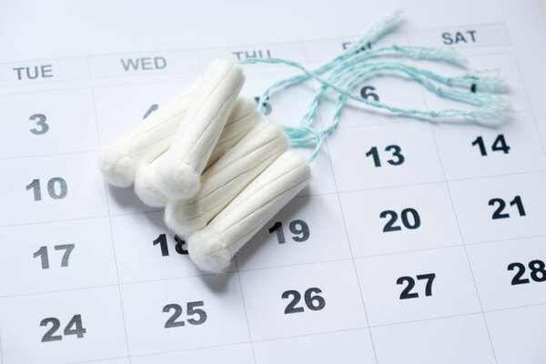 Menstrual tampon isolated on a calendar page