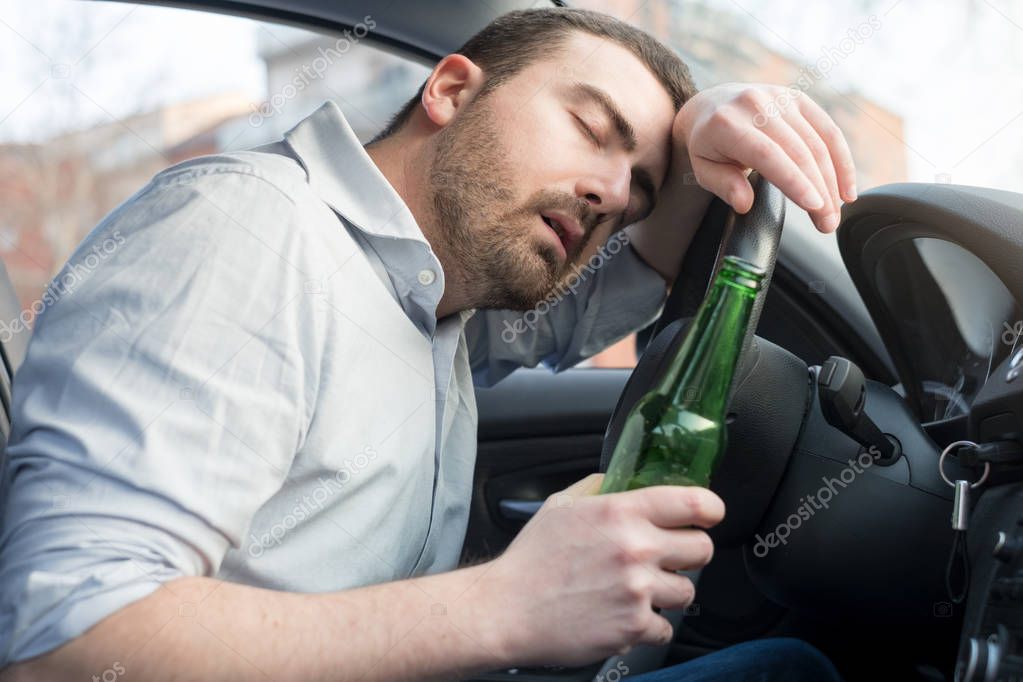 Drunk man driving car and falling asleep