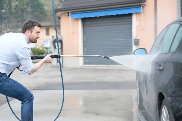 Man washing car in car wash station