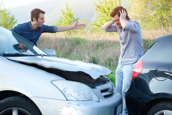 Two angry men arguing after a car crash