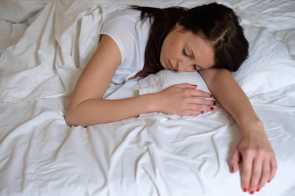 Mujer relajada y durmiendo en su cama — Foto de Stock