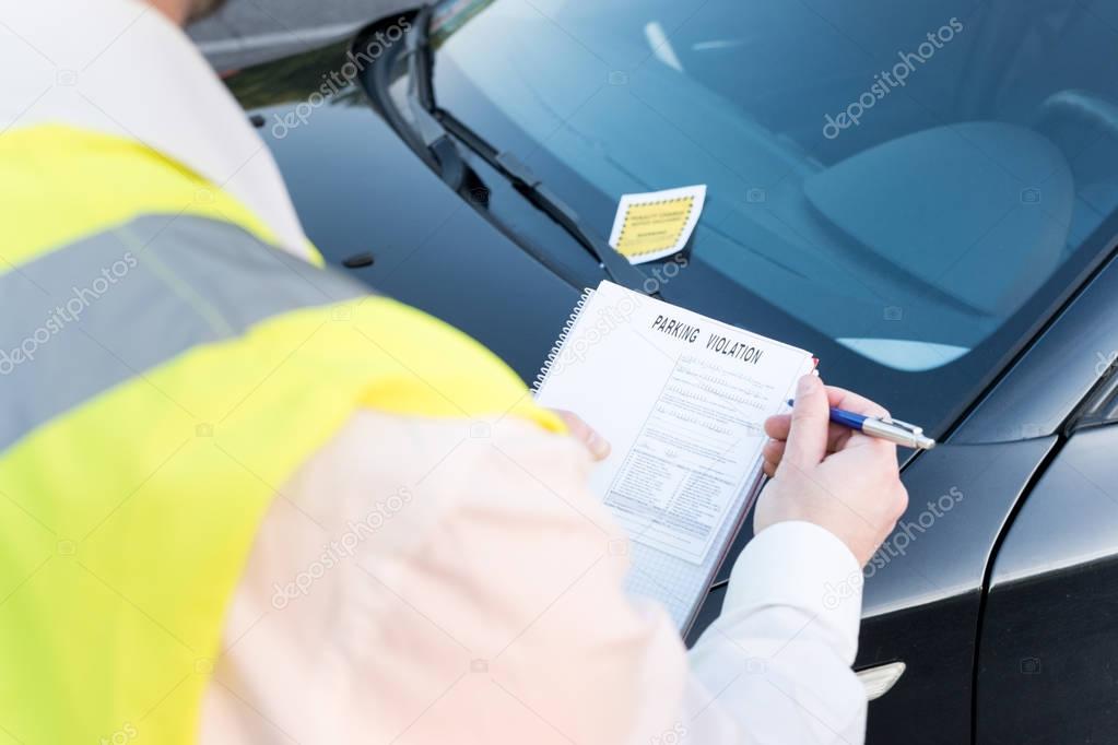Police officer giving a  fine for parking violation