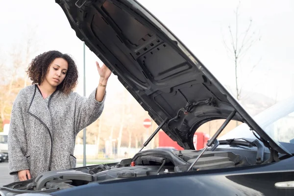 Отчаянная женщина после проверки автомобиля сломанный двигатель — стоковое фото