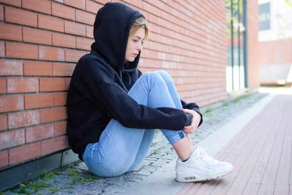 Alleen meisje portret met hooded sweatshirt volgende stedelijke straat wal — Stockfoto