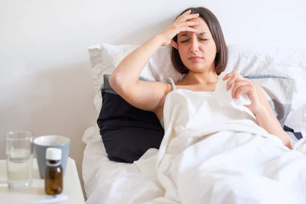 Ill woman feeling headache and lying in the bed — Stock Photo, Image