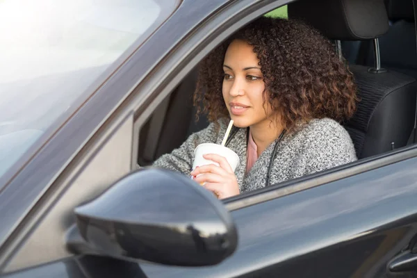 Afro mujer negra bebiendo y conduciendo — Foto de Stock