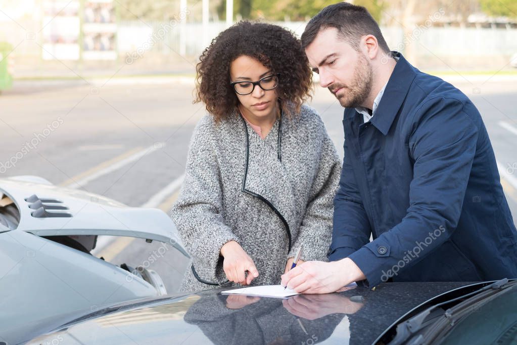 Man and woman filling an insurance car form