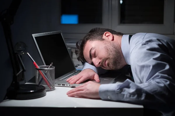 Tired businessman falling asleep on the desk — Stock Photo, Image
