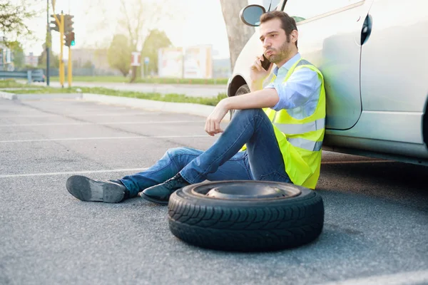 Hombre llamando al servicio de ayuda para un neumático pinchado — Foto de Stock