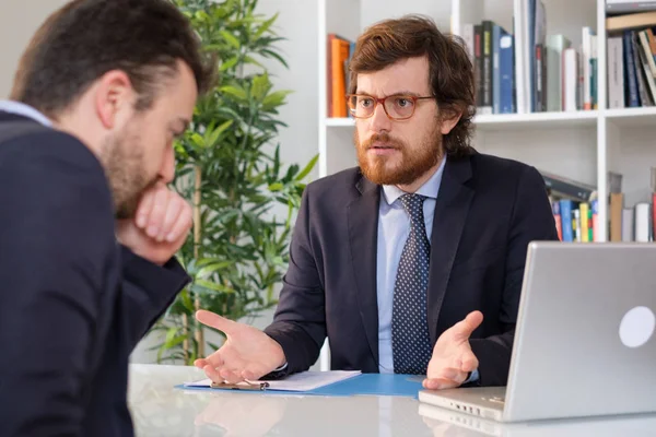 Angry boss arguing with an employee after a mistake