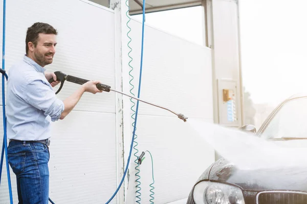 Homem de lavagem de carro na estação de lavagem de carro — Fotografia de Stock