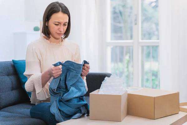 Woman feeling dissatisfied with received order at home