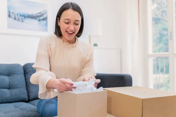 Woman feeling happy with received order at home