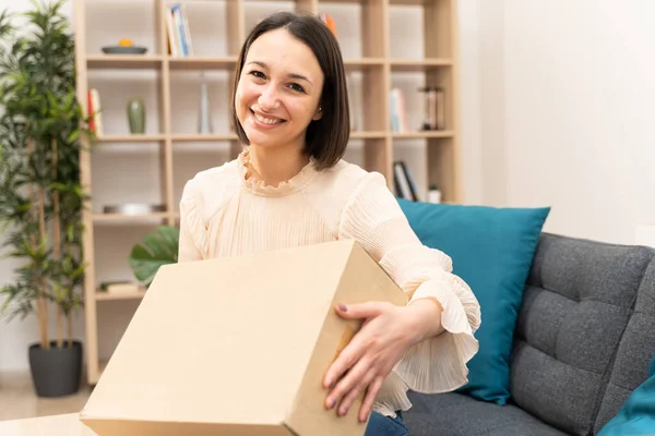 Woman feeling happy with received order at home