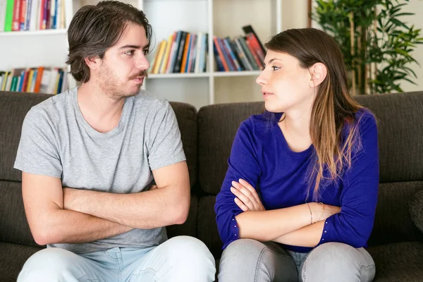 Young stressed couple quarrels among themselves at home