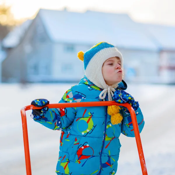 Little kid boy playing with snow in winter, outdoors — Stock Photo, Image