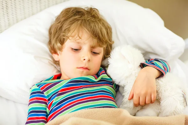 Kis szőke fiú színes hálóingben alszik — Stock Fotó