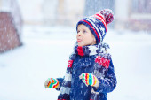 Šťastný chlapec baví se sněhem v zimě