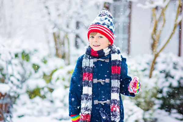 Glücklicher Junge, der im Winter Spaß mit Schnee hat — Stockfoto