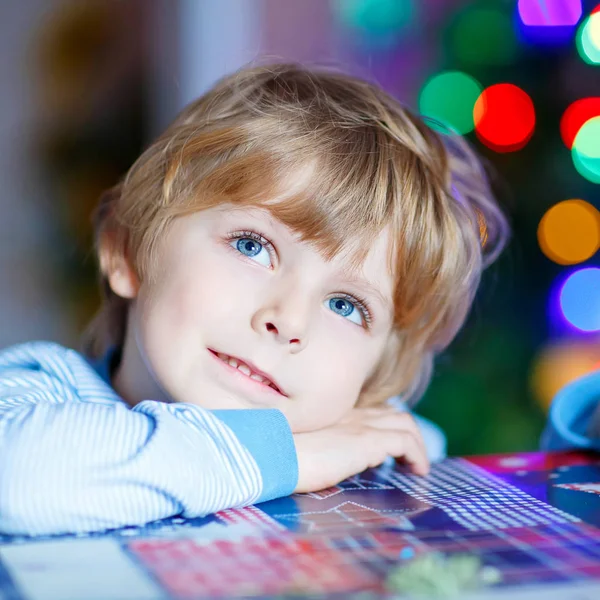Little blond child playing with cars and toys at home — Stock Photo, Image