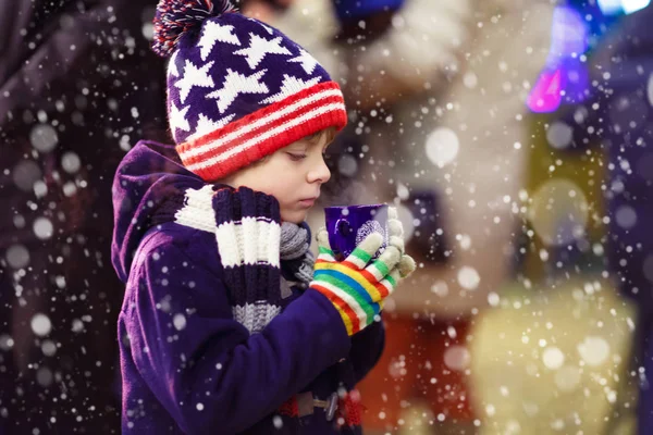 Petit garçon avec chocolat chaud sur le marché de Noël — Photo