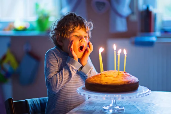 Little kid boy celebrating his birthday and blowing candles on cake — Stock Photo, Image