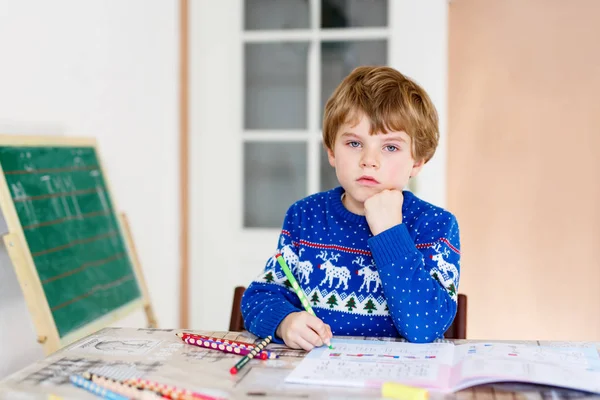 Menino da escola feliz em casa fazendo lição de casa — Fotografia de Stock