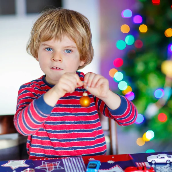 Little blond child playing with cars and toys at home — Stock Photo, Image