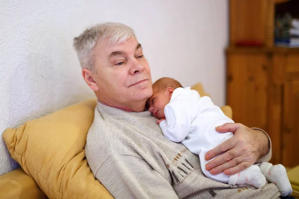 Happy grandfather holding newborn baby grandchild on arms — Stock Photo, Image