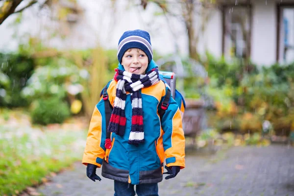 Happy kid boy having fun with snow on way to school — Stock Photo, Image