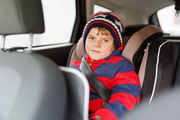 Little kid boy sitting in safety car seat during trip — Stock Photo, Image