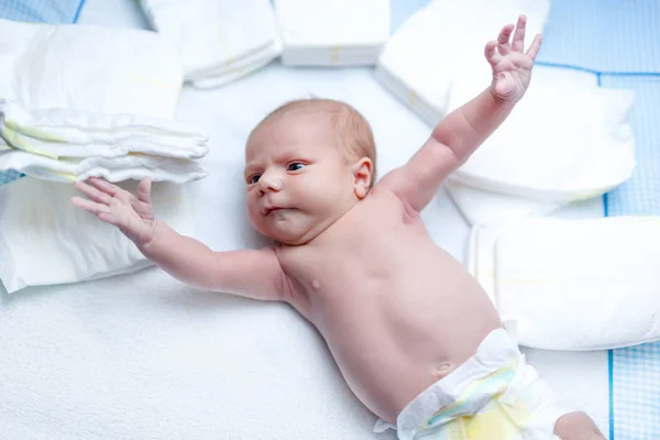 Newborn baby on changing table with diapers — Stock Photo, Image
