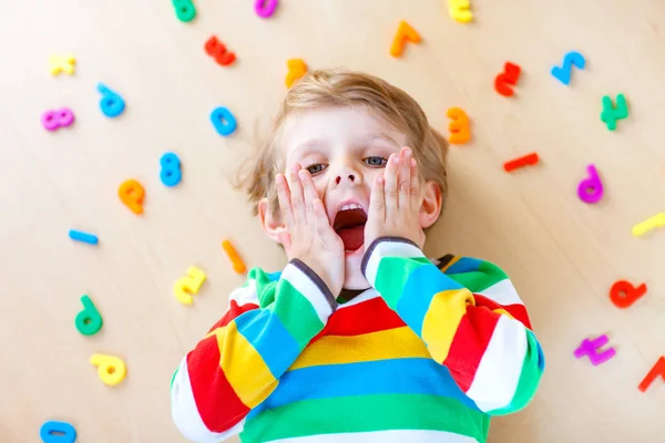 Kid boy with colorful numbers, indoor — Stock Photo, Image