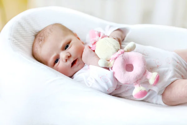 Cute baby girl playing with plush animal toy — Stock Photo, Image